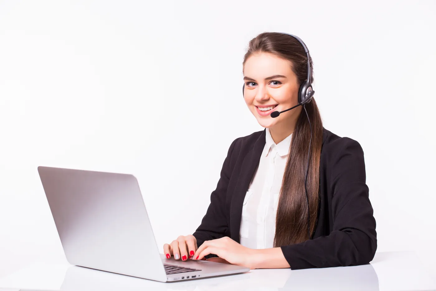 Support agent with a headset working on a laptop