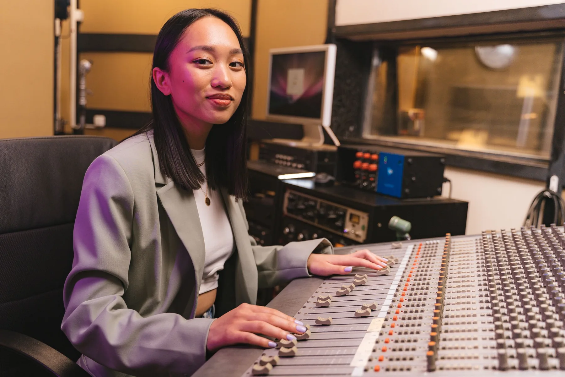 A sound engineer at a professional audio mixing console